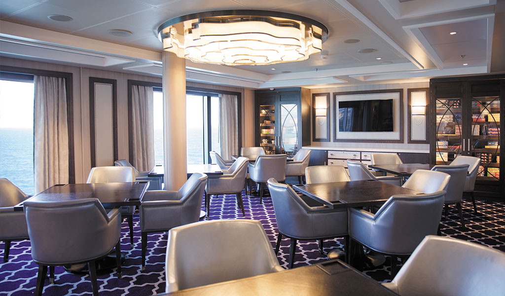 the card room aboard Seven Seas Splendor with leather seats and games
